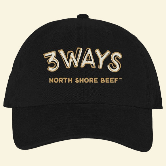 Black hat with horizontal gold and off white 3Ways North Shore Beef logo