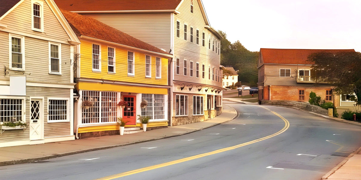 Main street in a North Shore town with clapboard shops and a curving road
