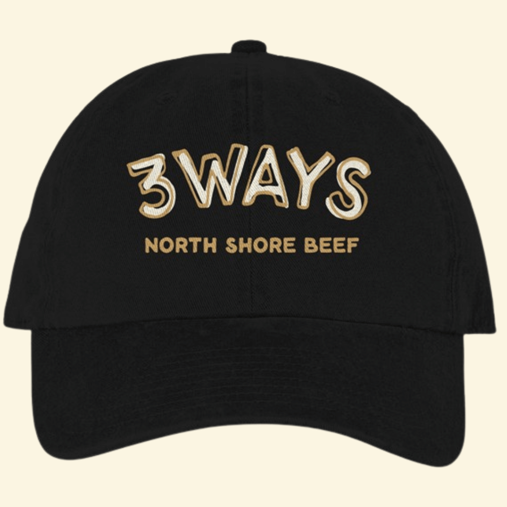 Black hat with horizontal gold and off white 3Ways North Shore Beef logo